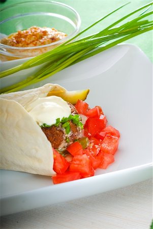 fresh traditional falafel wrap on pita bread with fresh chopped tomatoes Stock Photo - Budget Royalty-Free & Subscription, Code: 400-04870527