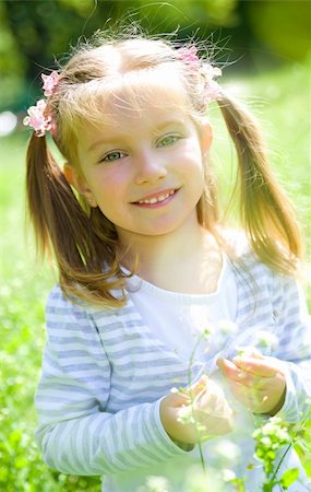 Cute little girl  on the meadow in spring day Stock Photo - Budget Royalty-Free & Subscription, Code: 400-04870776
