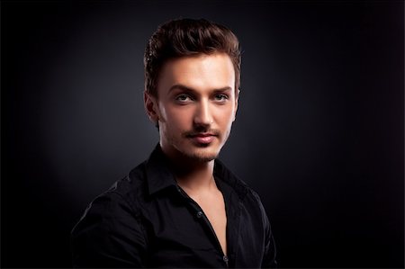 Young man's portrait. Close-up face against black background Stockbilder - Microstock & Abonnement, Bildnummer: 400-04871011