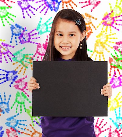 simsearch:400-04340435,k - Young Cheerful Girl With A Blank Board And Wall With Colored Hands In The Background Stock Photo - Budget Royalty-Free & Subscription, Code: 400-04871124