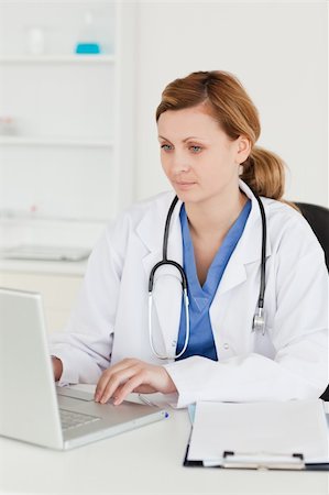 simsearch:400-04191693,k - Concentrated doctor working on her laptop in her surgery Stock Photo - Budget Royalty-Free & Subscription, Code: 400-04871343