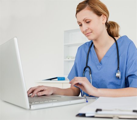 simsearch:400-04191693,k - Young female doctor working on her laptop in her surgery Stock Photo - Budget Royalty-Free & Subscription, Code: 400-04871358