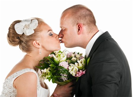 simsearch:400-07332647,k - groom and bride are holding bridal bouquet and kissing, cut out from white Stockbilder - Microstock & Abonnement, Bildnummer: 400-04872280