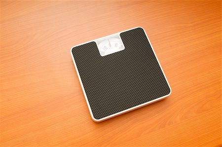 simsearch:400-08260357,k - Dieting concept with scales on the wooden floor Stock Photo - Budget Royalty-Free & Subscription, Code: 400-04872627