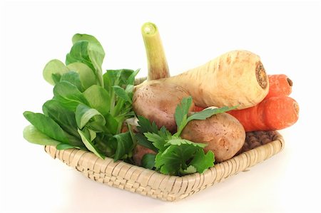 Corn salad, parsley root, mushrooms, carrots, parsley and garlic in the basket on a white background Stock Photo - Budget Royalty-Free & Subscription, Code: 400-04872969