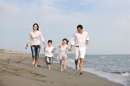 happy young family have fun and live healthy lifestyle on beach Stock Photo - Budget Royalty-Free & Subscription, Code: 400-04873158