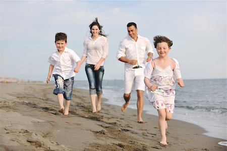 happy young family have fun and live healthy lifestyle on beach Stock Photo - Budget Royalty-Free & Subscription, Code: 400-04873159