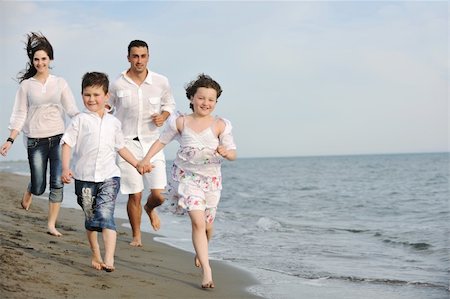 happy young family have fun and live healthy lifestyle on beach Stock Photo - Budget Royalty-Free & Subscription, Code: 400-04873161