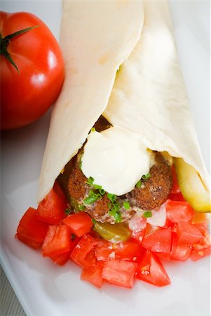 fresh traditional falafel wrap on pita bread with fresh chopped tomatoes Stock Photo - Budget Royalty-Free & Subscription, Code: 400-04873215