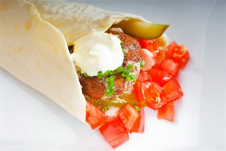 fresh traditional falafel wrap on pita bread with fresh chopped tomatoes Stock Photo - Budget Royalty-Free & Subscription, Code: 400-04873217