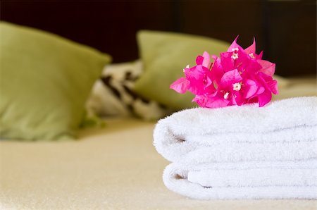 simsearch:400-04873467,k - White towels with flowers on a bed in a hotel room. Selective focus on flowers. Stock Photo - Budget Royalty-Free & Subscription, Code: 400-04873467