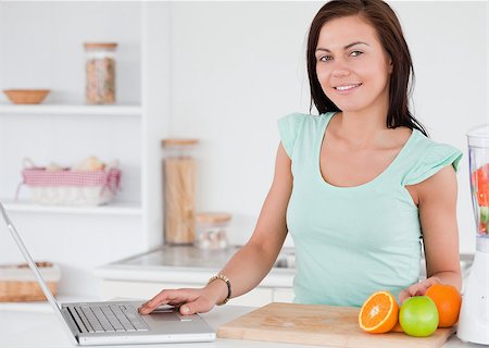 Woman with a laptop and fruits Stock Photo - Budget Royalty-Free & Subscription, Code: 400-04884115