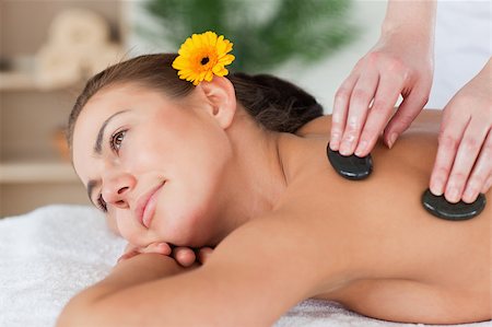 simsearch:400-04881816,k - Close up of a cute woman enjoying a hot stone massage in a spa Stockbilder - Microstock & Abonnement, Bildnummer: 400-04884162