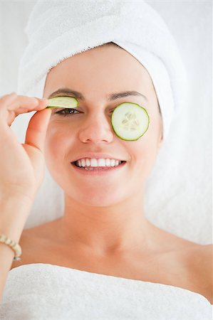Young woman with a knowing smile with cucumber slices on the face in a spa Stock Photo - Budget Royalty-Free & Subscription, Code: 400-04884188