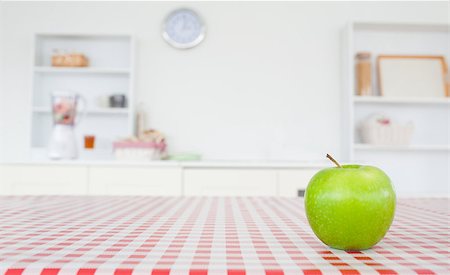 simsearch:400-07714506,k - An apple on a tablecloth in a kitchen Photographie de stock - Aubaine LD & Abonnement, Code: 400-04884201