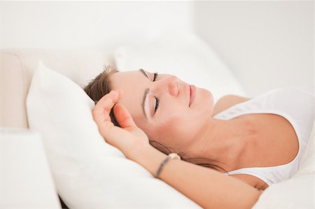 simsearch:400-04206266,k - Brunette sleeping in her bed against a white background Stockbilder - Microstock & Abonnement, Bildnummer: 400-04884401