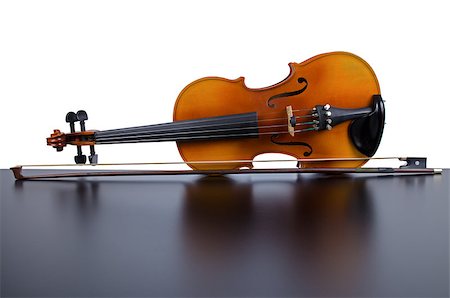 simsearch:400-04794644,k - Violin on top of dark table partially isolated on white background. Photographie de stock - Aubaine LD & Abonnement, Code: 400-04885744