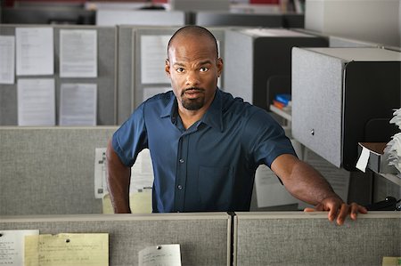 Calm Latino office worker standing in his cubicle Stock Photo - Budget Royalty-Free & Subscription, Code: 400-04885926