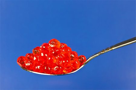 fish red spoon - red salmon roe in a spoon over blue background Stock Photo - Budget Royalty-Free & Subscription, Code: 400-04886071