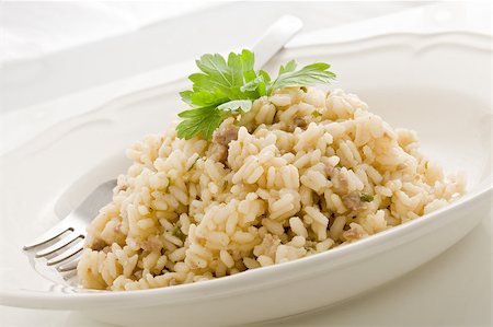 photo of delicious italian risotto dish with meat and parsley on white isolated background Stockbilder - Microstock & Abonnement, Bildnummer: 400-04887449