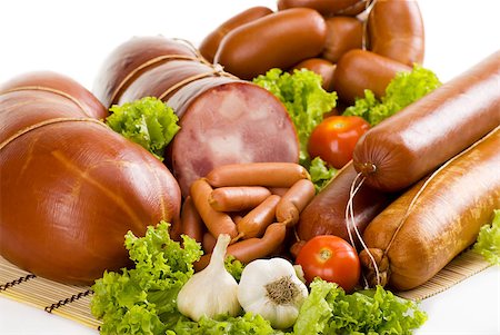 Sausages and ham with lettuce, garlic and tomatoes Stock Photo - Budget Royalty-Free & Subscription, Code: 400-04887521