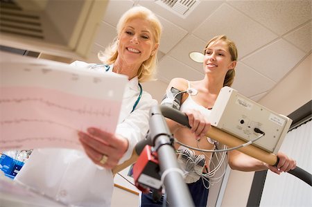 Doctor Monitoring The Heart-Rate Of Patient On A Treadmill Stock Photo - Budget Royalty-Free & Subscription, Code: 400-04887835