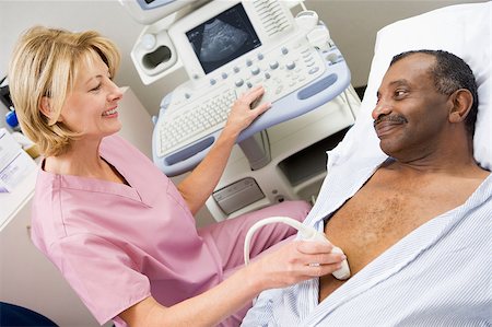 simsearch:400-04887902,k - Nurse Giving Patient An Ultra Sound Stock Photo - Budget Royalty-Free & Subscription, Code: 400-04887886