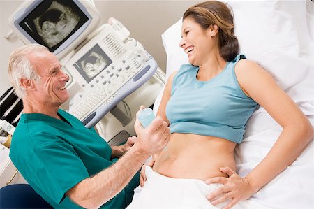 pregnant scan - Doctor Giving Patient An Ultra Sound Stock Photo - Budget Royalty-Free & Subscription, Code: 400-04887887