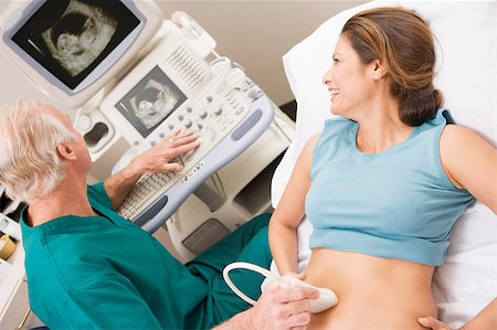 pregnant scan - Doctor Giving Patient An Ultra Sound Stock Photo - Budget Royalty-Free & Subscription, Code: 400-04887888
