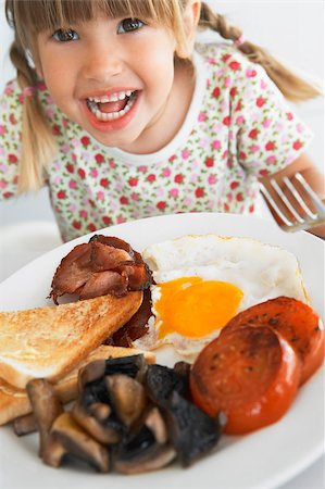 person eating bacon - Toddler Eating Unhealthy Breakfast Stock Photo - Budget Royalty-Free & Subscription, Code: 400-04888265