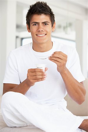 Young Man Eating Yogurt Stock Photo - Budget Royalty-Free & Subscription, Code: 400-04888415