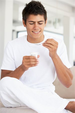 Young Man Eating Yogurt Stock Photo - Budget Royalty-Free & Subscription, Code: 400-04888416