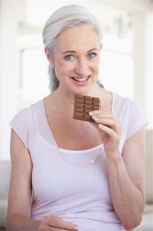 Senior Woman Eating Chocolate Stock Photo - Budget Royalty-Free & Subscription, Code: 400-04888444