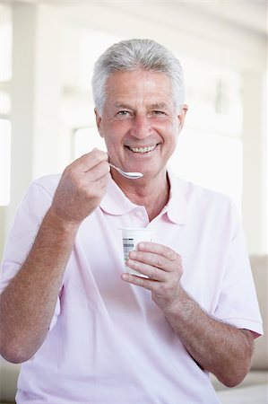 Middle Aged Man Eating Yogurt Stock Photo - Budget Royalty-Free & Subscription, Code: 400-04888450