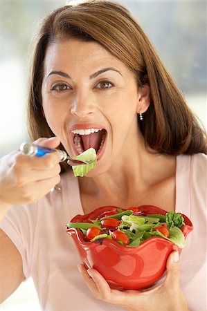 simsearch:649-07559812,k - Mid Adult Woman Eating A Fresh Green Salad Stock Photo - Budget Royalty-Free & Subscription, Code: 400-04888502