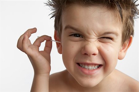 Boy cleans his ear. Isolated white background Stock Photo - Budget Royalty-Free & Subscription, Code: 400-04889311