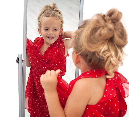 Little girl trying large dress in front of mirror - isolated Stock Photo - Budget Royalty-Free & Subscription, Code: 400-04889734