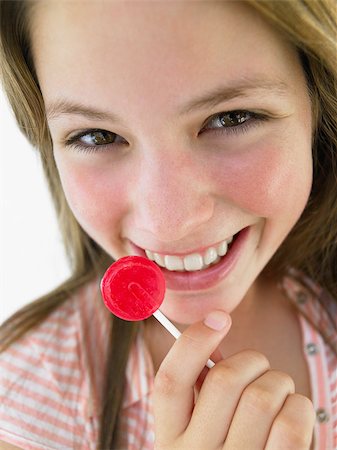 Portrait Of Teenage Girl Eating Lollipop Stock Photo - Budget Royalty-Free & Subscription, Code: 400-04889888