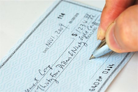 Writing a check to pay for the bill Stock Photo - Budget Royalty-Free & Subscription, Code: 400-04880043