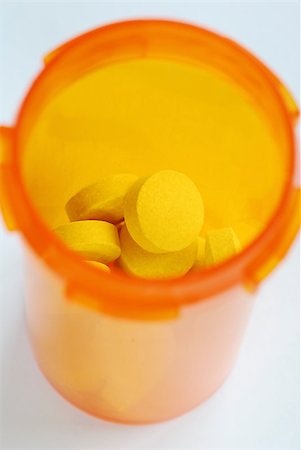 The medicine bottle with some yellow pills Stock Photo - Budget Royalty-Free & Subscription, Code: 400-04880063