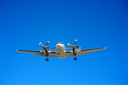 Twin engine propeller airplane approaching for landing Stock Photo - Budget Royalty-Free & Subscription, Code: 400-04880687