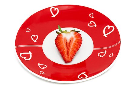 simsearch:400-05265200,k - Deliciously half a red strawberry on the romantic red plate Photographie de stock - Aubaine LD & Abonnement, Code: 400-04880896