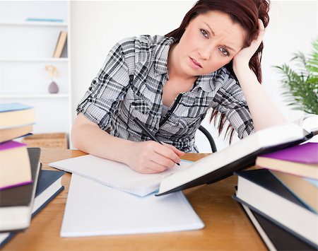 simsearch:400-05678149,k - Good looking depressed female studying at her desk Stockbilder - Microstock & Abonnement, Bildnummer: 400-04880922