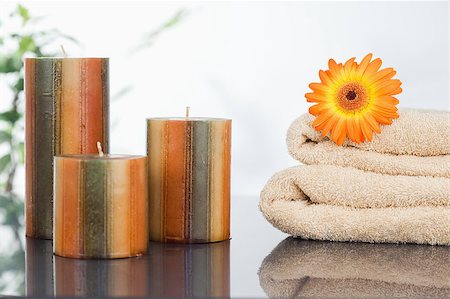 simsearch:400-04881211,k - Unlighted candles with an orange gerbera on towels Stock Photo - Budget Royalty-Free & Subscription, Code: 400-04881203