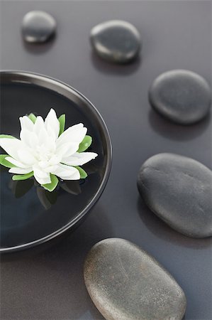 spa background - Close up of a white flower floating in a black bowl surrounded by black pebbles Stock Photo - Budget Royalty-Free & Subscription, Code: 400-04881219