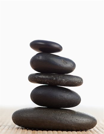 A black stones stack against a white background Stock Photo - Budget Royalty-Free & Subscription, Code: 400-04881282