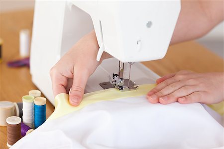 Caucasian hands using a sewing machine in the living room Stock Photo - Budget Royalty-Free & Subscription, Code: 400-04881562