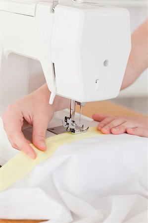 Caucasian hands using a sewing machine in the living room Stock Photo - Budget Royalty-Free & Subscription, Code: 400-04881563