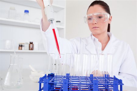 Pretty female biologist holding a manual pipette with sample from test tubes in a lab Stock Photo - Budget Royalty-Free & Subscription, Code: 400-04881574