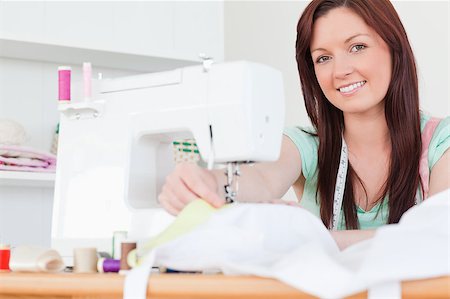 Beautiful red-haired female sewing in her living room Stock Photo - Budget Royalty-Free & Subscription, Code: 400-04881570